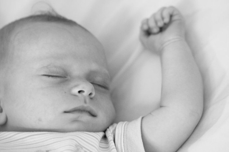 Sleeping baby with extended arm