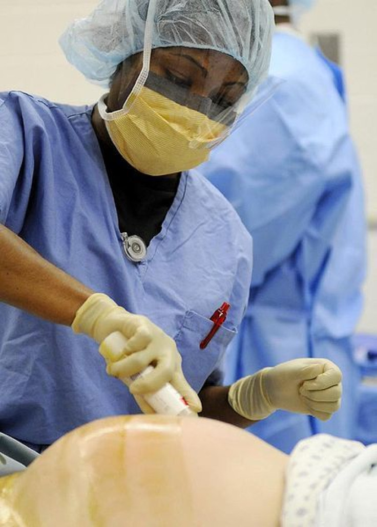 US Navy nurse prepares a mom for a C-section