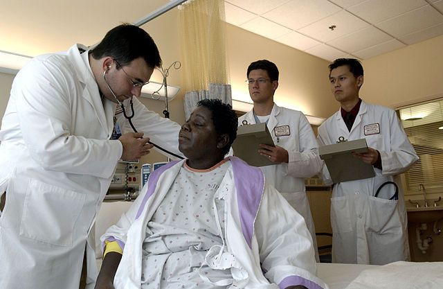 Doctor examines patient with stethoscope