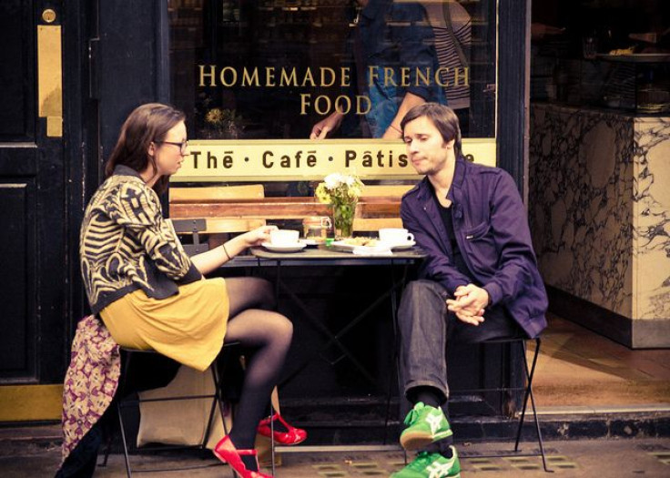 Couple sitting in front of restaurant