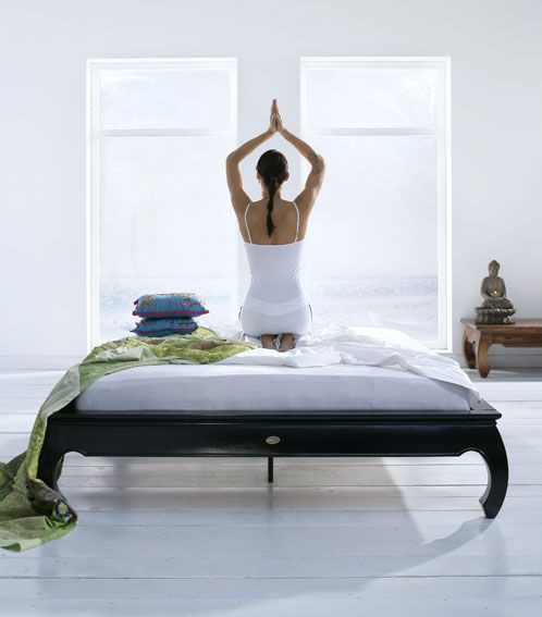 Woman on bed stretching