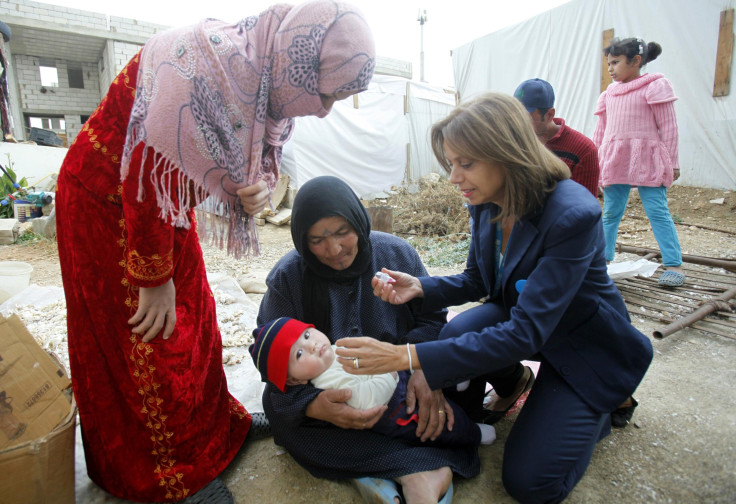 a health worker vaccinates Syrian child