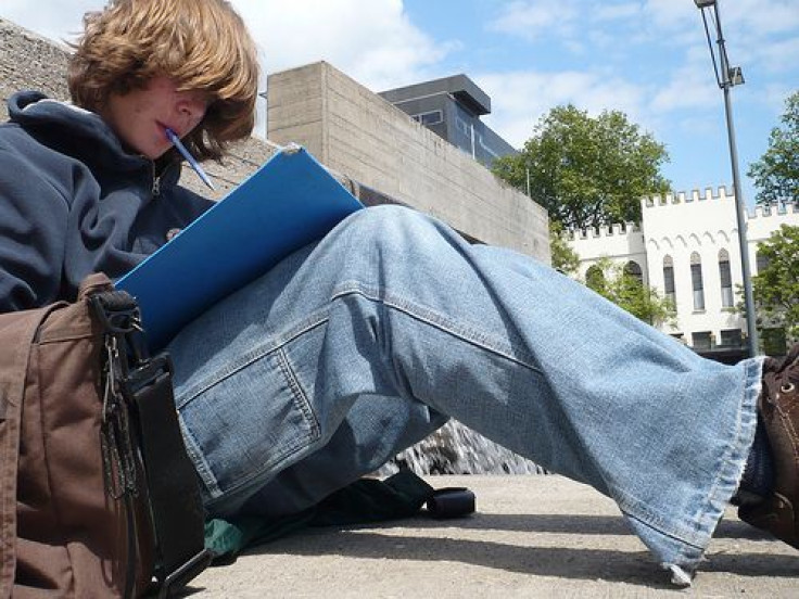 Boy studying on the ground