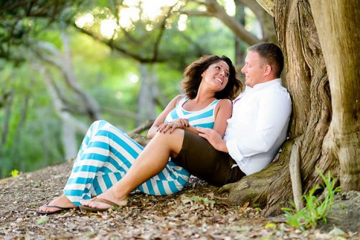Couple lying down near tree