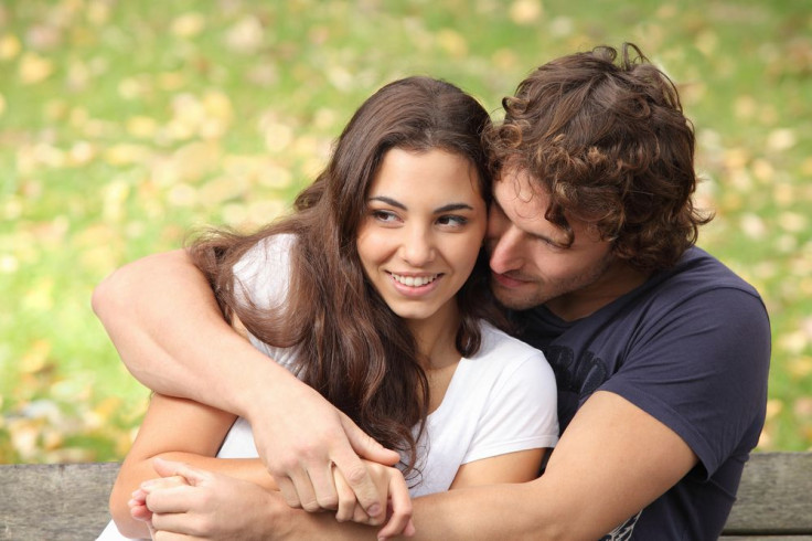 Couple hugging each other on bench