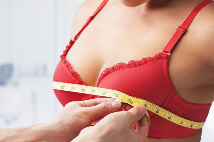 Woman getting measured for bra size