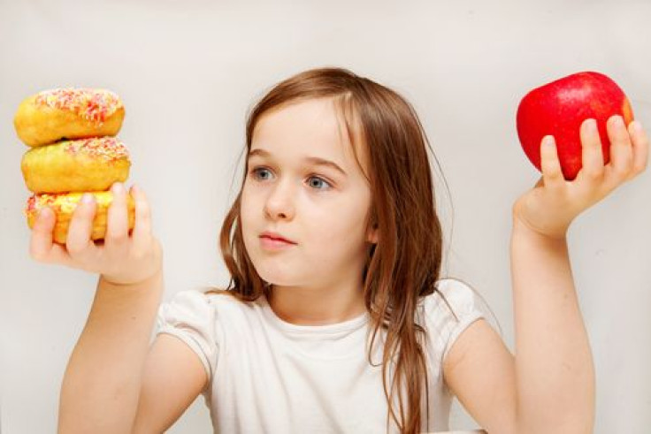 Young girl contemplating what to eat