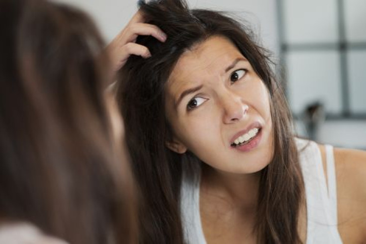 Woman scratching head