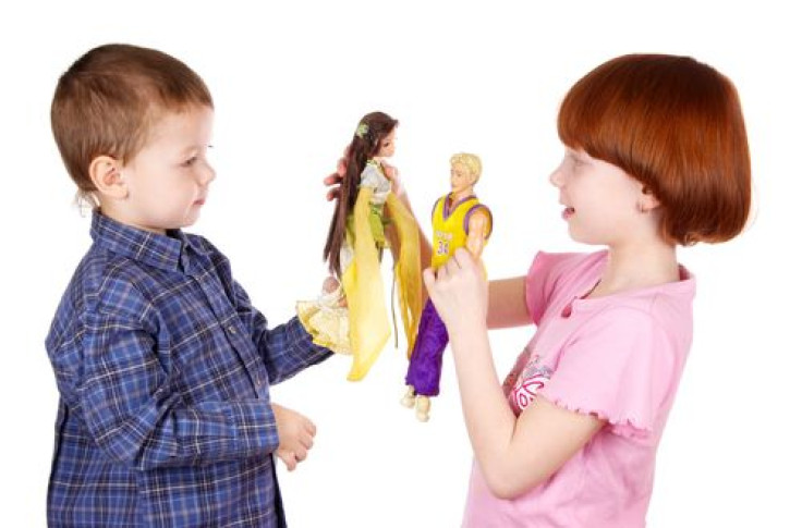Brother and sister playing dolls