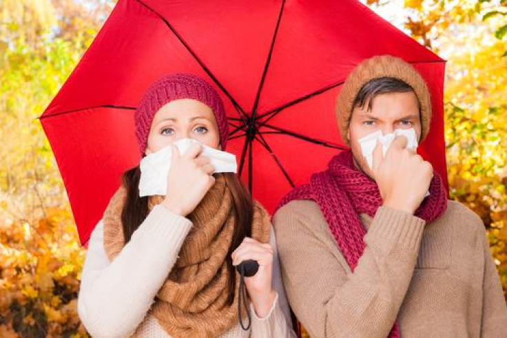 Couple under an umbrella suffering weather illness