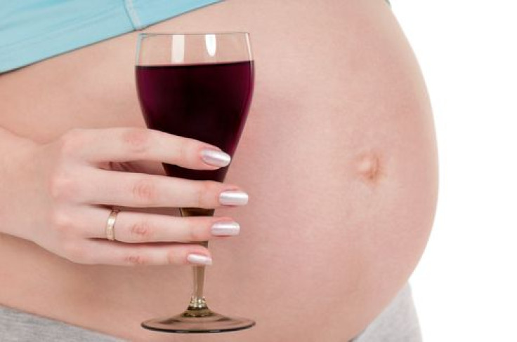 Pregnant belly with wine
