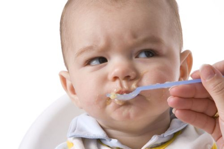 Baby boy being fed with a spoon