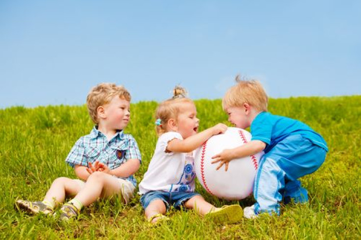 Toddlers fighting for a ball