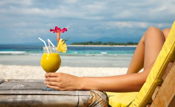 Woman having cocktail on the beach