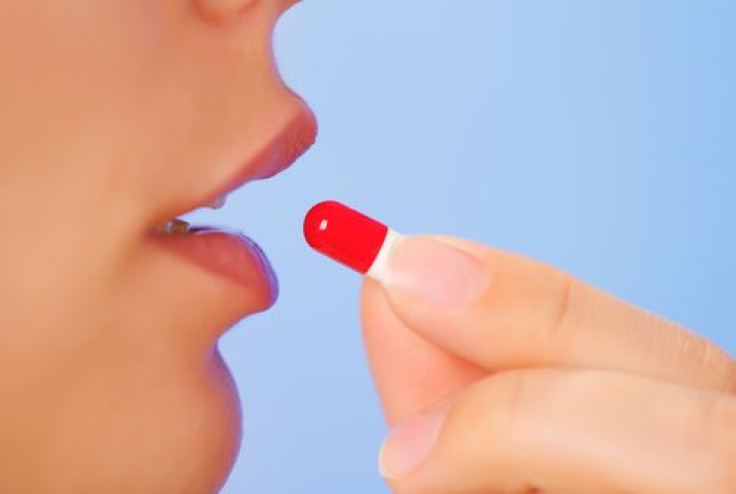 Woman taking antioxidant supplement 