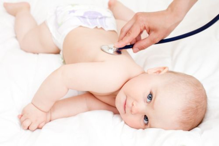 Doctor examining infant