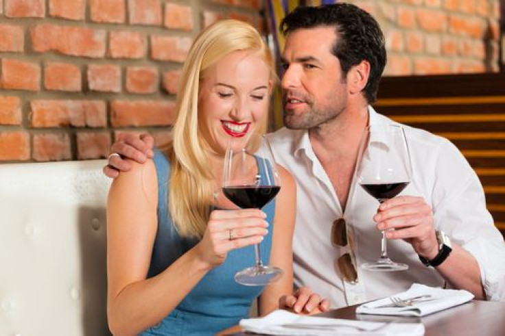 Man and woman on a date drinking wine at a restaurant