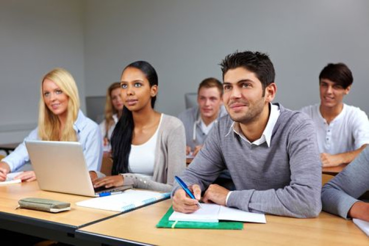 College students taking notes in a classroom