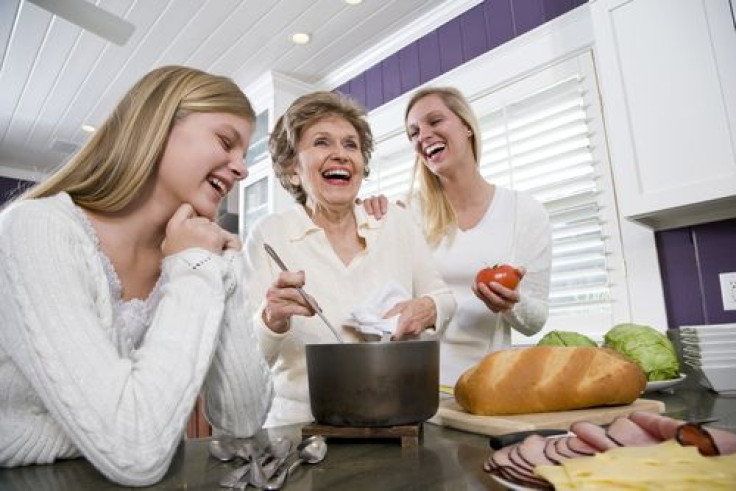 Three generation family in kitchen talking. 