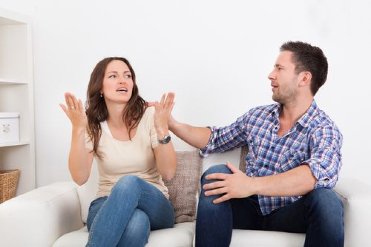 Frustrated couple on couch fighting with each other