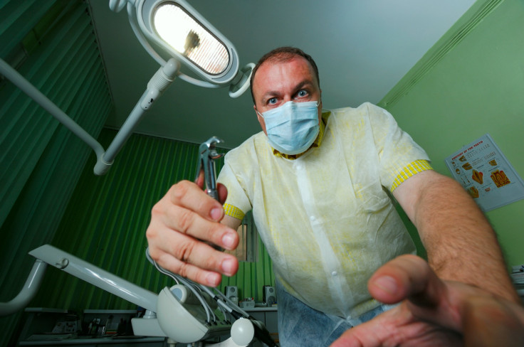 Scary dentist wielding tools