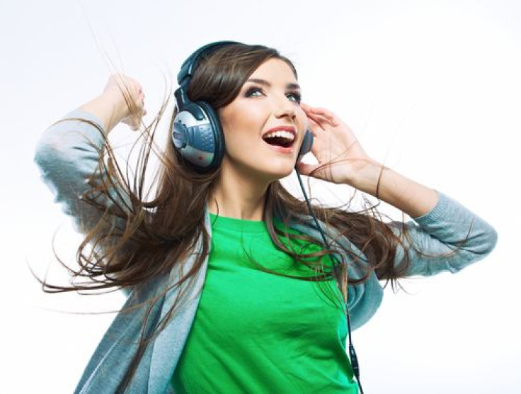 Woman happily listening to music with headphones