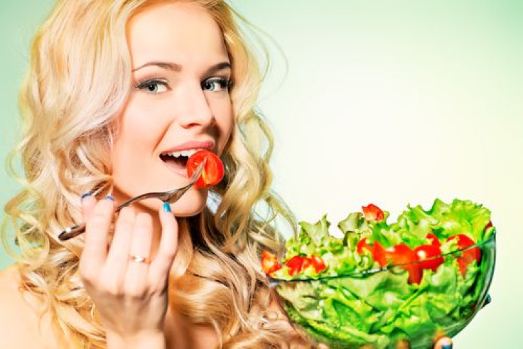 Woman eating a salad in a bowl