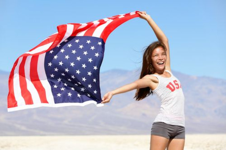 Happy woman waving American flag