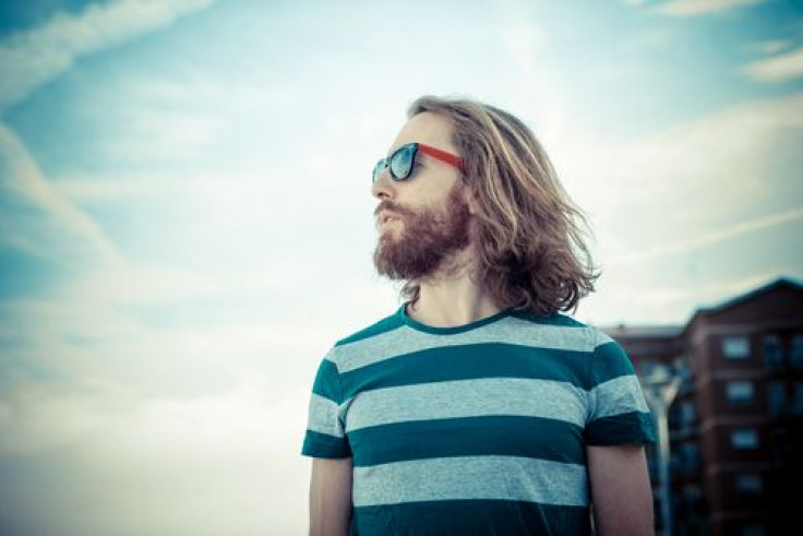 Hipster with sunglasses and beard outside in the sun 