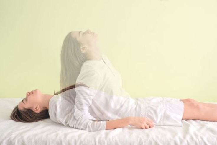 Woman is waking up again on bed as soul leaves body