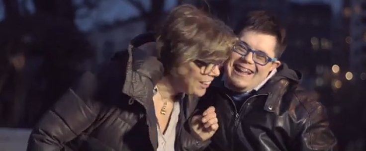 Man with Down syndrome and his mom laughing and hugging