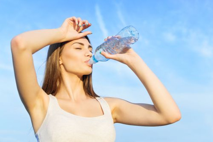 Woman drinking water after workout