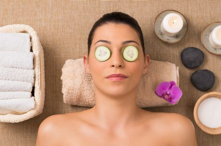 Woman receiving beauty treatment with cucumber slices on her eyes