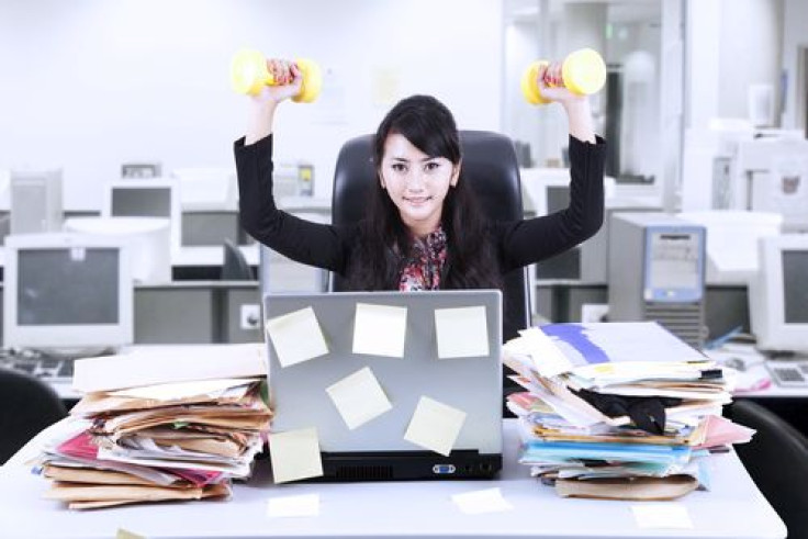 Woman doing exercise in front of her laptop