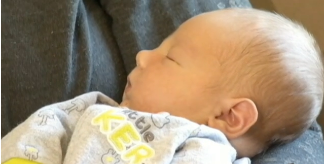 Mom holds newborn baby after cryptic pregnancy