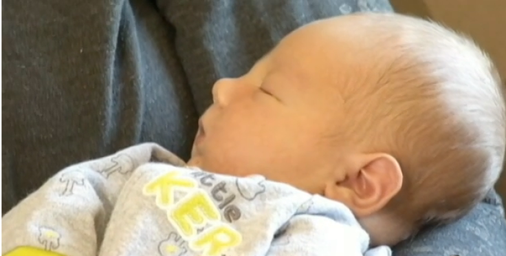 Mom holds newborn baby after cryptic pregnancy 
