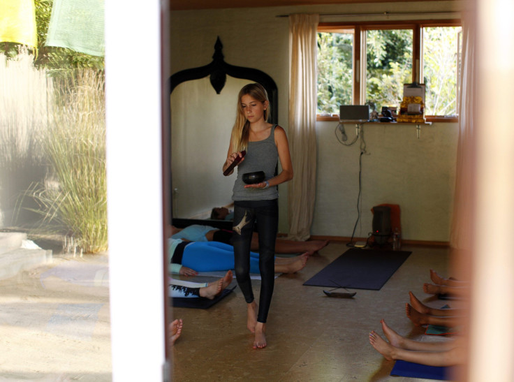 Jaysee Devoe practicing yoga in her yoga studio