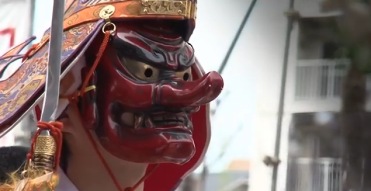 Man wearing mask at penis festival