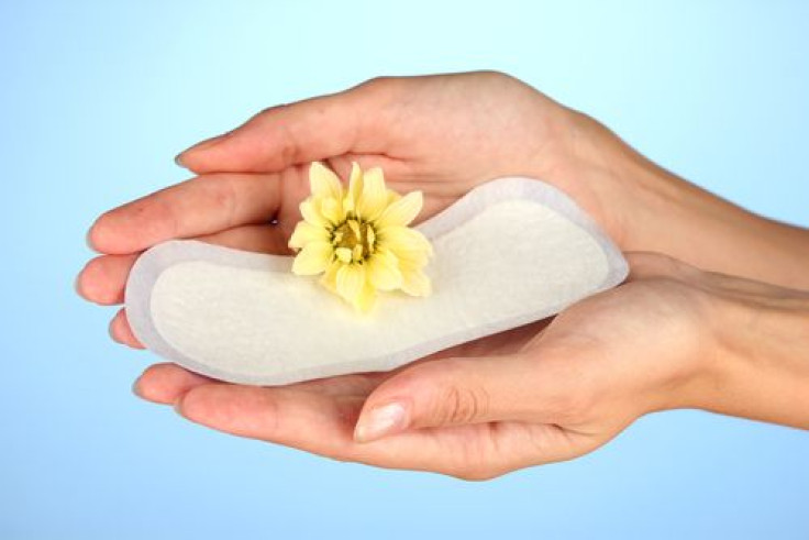 Woman holding daily sanitary pad with flower