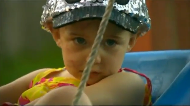 Kenzi on swing in backyard