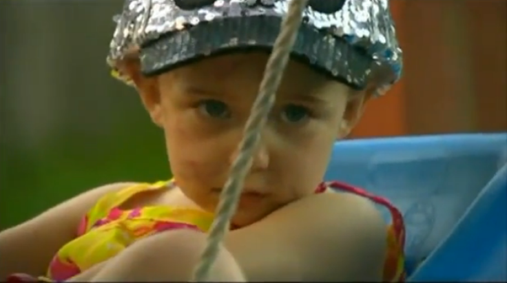 Kenzi on swing in backyard 