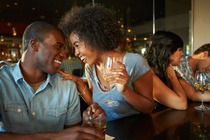 Man and woman enjoying a drink at the bar