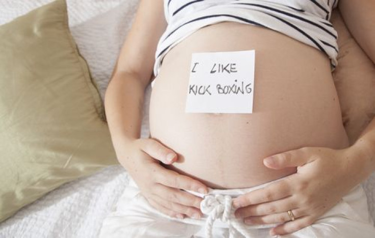 Pregnant woman with post-it on belly