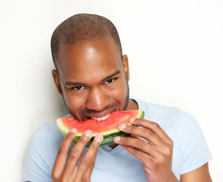Man smiling and eating watermelon