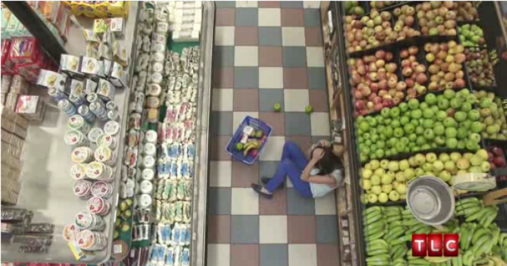 Ashley hits head on produce and falls to the ground