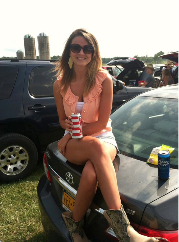 Jenna outside in top of car drinking