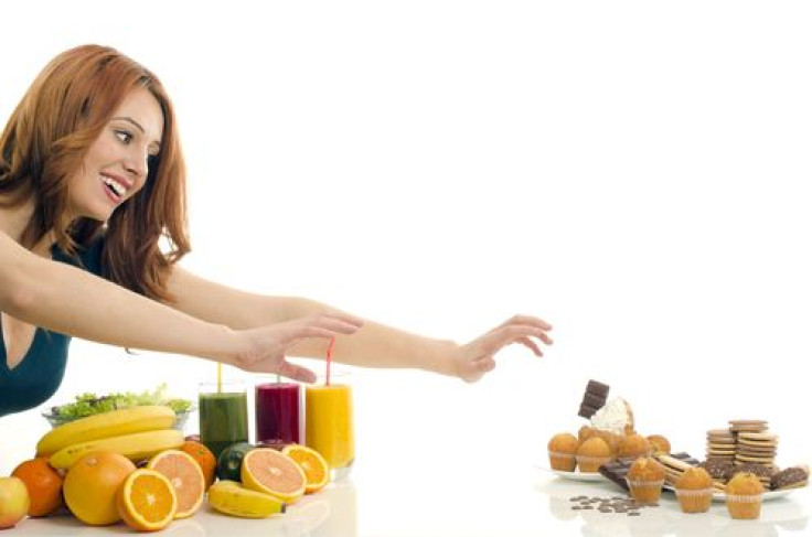 Woman choosing between healthy food and unhealthy food