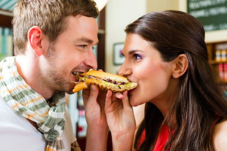 Couple eating hot dog together