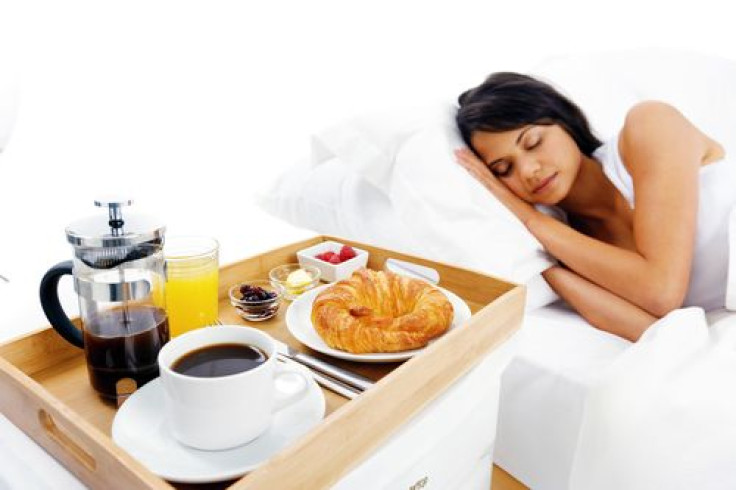 Woman sleeping next to breakfast cart