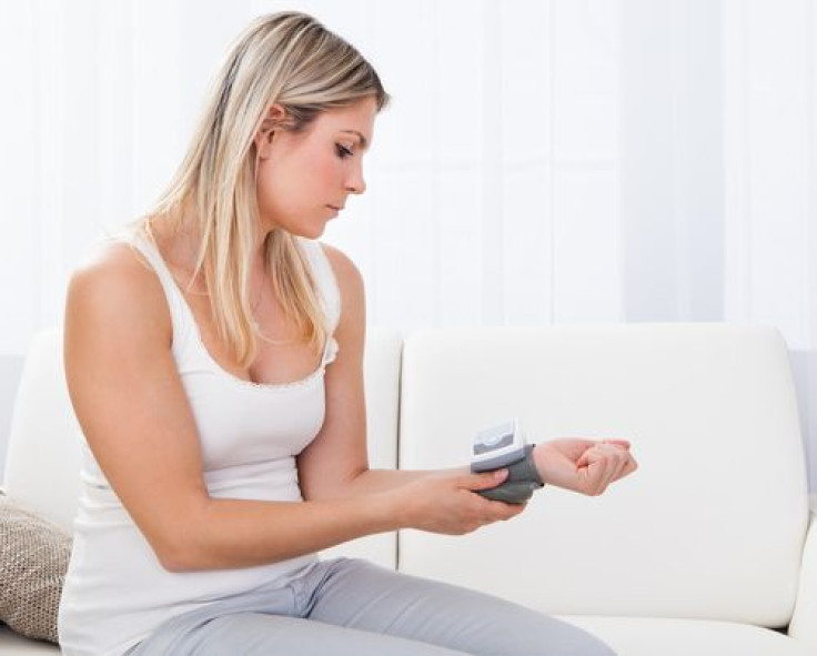 Woman measuring her blood pressure